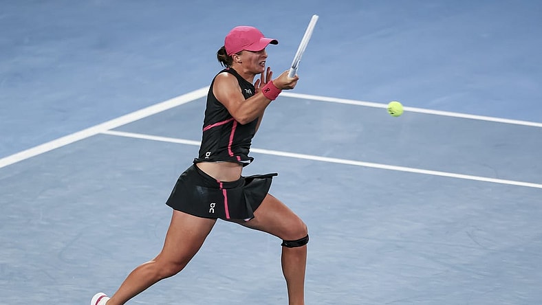 Jan 20, 2024; Melbourne, Victoria, Australia; Iga Swiatek of Poland plays a shot against Linda Noskova (not pictured) of Czechia in Round 3 of the Women's Singles on Day 7 of the Australian Open tennis at Rod Laver Arena. Mandatory Credit: Mike Frey-USA TODAY Sports