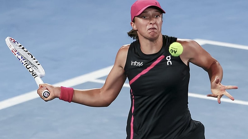 Jan 20, 2024; Melbourne, Victoria, Australia; Iga Swiatek of Poland plays a shot against Linda Noskova (not pictured) of Czechia in Round 3 of the Women's Singles on Day 7 of the Australian Open tennis at Rod Laver Arena. Mandatory Credit: Mike Frey-USA TODAY Sports