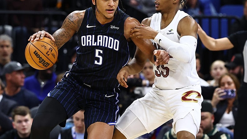 Jan 22, 2024; Orlando, Florida, USA; Cleveland Cavaliers forward Isaac Okoro (35) defends Orlando Magic forward Paolo Banchero (5) during the second quarter at Kia Center. Mandatory Credit: Kim Klement Neitzel-USA TODAY Sports