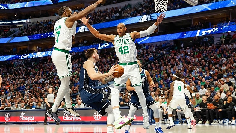 Jan 22, 2024; Dallas, Texas, USA; Dallas Mavericks guard Luka Doncic (77) looks to shoot with Boston Celtics center Al Horford (42) and guard Jaylen Brown (7) defending during the third quarter at American Airlines Center. Mandatory Credit: Andrew Dieb-USA TODAY Sports