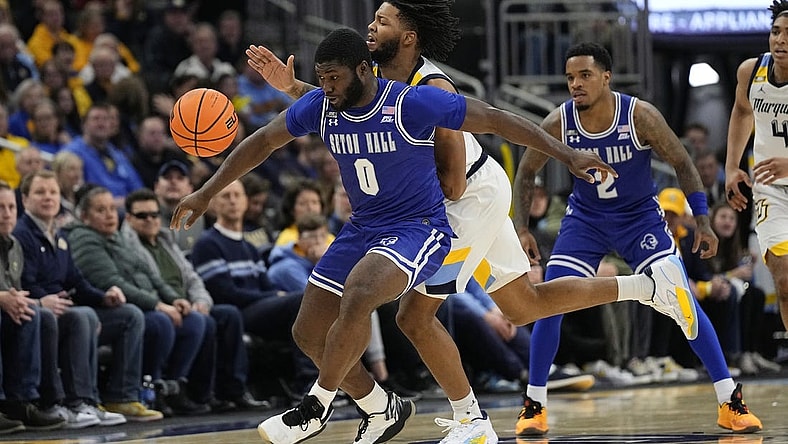 Jan 27, 2024; Milwaukee, Wisconsin, USA;  Seton Hall Pirates guard Dylan Addae-Wusu (0) and Marquette Golden Eagles forward David Joplin (23) chase the loose ball during the second half at Fiserv Forum. Mandatory Credit: Jeff Hanisch-USA TODAY Sports
