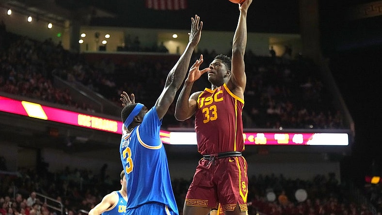Jan 27, 2024; Los Angeles, California, USA; Southern California Trojans forward Kijani Wright (33) shoots the ball against UCLA Bruins forward Adem Bona (3) in the second half at Galen Center. Mandatory Credit: Kirby Lee-USA TODAY Sports