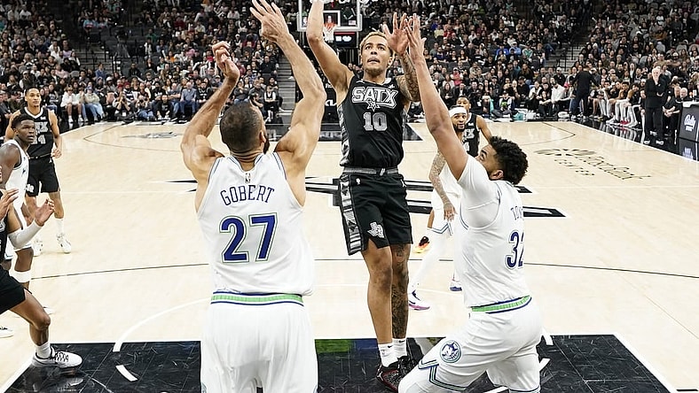 Jan 27, 2024; San Antonio, Texas, USA; San Antonio Spurs forward Jeremy Sochan (10) drives to the basket past Minnesota Timberwolves centers Rudy Gobert (27) and Karl-Anthony Towns (32) during the second half at Frost Bank Center. Mandatory Credit: Scott Wachter-USA TODAY Sports