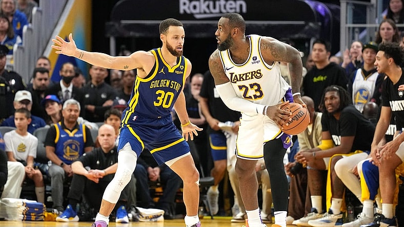 Jan 27, 2024; San Francisco, California, USA; Golden State Warriors guard Stephen Curry (30) defends against Los Angeles Lakers forward LeBron James (23) during overtime at Chase Center. Mandatory Credit: Darren Yamashita-USA TODAY Sports