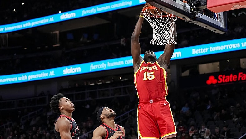 Jan 28, 2024; Atlanta, Georgia, USA; Atlanta Hawks center Clint Capela (15) dunks behind Toronto Raptors forwards Scottie Barnes (4) and Bruce Brown (11) during the first half at State Farm Arena. Mandatory Credit: Dale Zanine-USA TODAY Sports