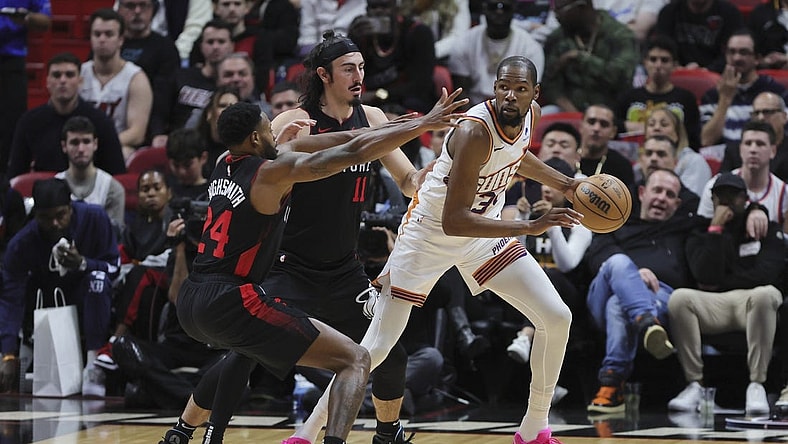 Jan 29, 2024; Miami, Florida, USA; Phoenix Suns forward Kevin Durant (35) protects the basketball from Miami Heat forward Haywood Highsmith (24) and guard Jaime Jaquez Jr. (11) during the third quarter at Kaseya Center. Mandatory Credit: Sam Navarro-USA TODAY Sports