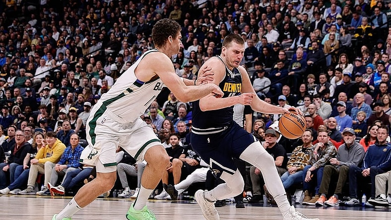 Jan 29, 2024; Denver, Colorado, USA; Denver Nuggets center Nikola Jokic (15) controls the ball against Milwaukee Bucks center Brook Lopez (11) in the fourth quarter at Ball Arena. Mandatory Credit: Isaiah J. Downing-USA TODAY Sports