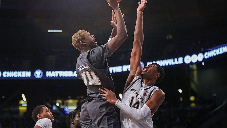 Jan 9, 2024; Atlanta, Georgia, USA; Georgia Tech Yellow Jackets guard Kowacie Reeves Jr. (14) shoots over Notre Dame Fighting Irish forward Kebba Njie (14) in the second half at McCamish Pavilion. Mandatory Credit: Brett Davis-USA TODAY Sports