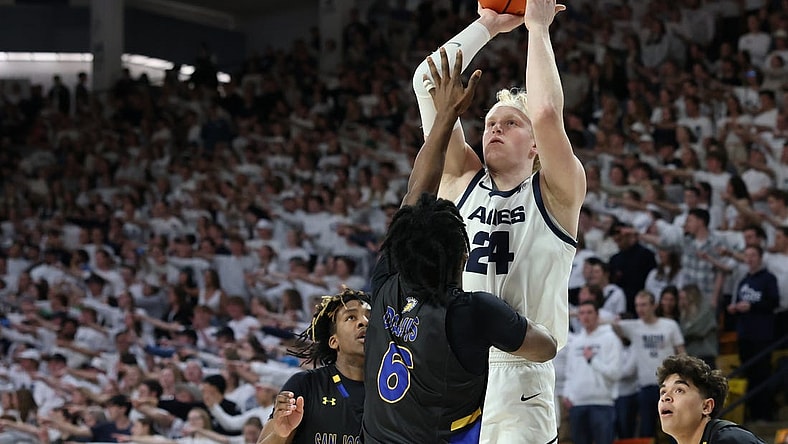 Jan 30, 2024; Logan, Utah, USA; Utah State Aggies forward Karson Templin (24) shoots over San Jose State Spartans guard Latrell Davis (6) during the second half at Dee Glen Smith Spectrum. Mandatory Credit: Rob Gray-USA TODAY Sports