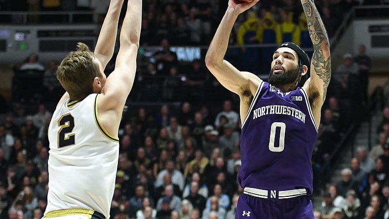 Jan 31, 2024; West Lafayette, Indiana, USA; Northwestern Wildcats guard Boo Buie (0) attempts a shot over Purdue Boilermakers guard Fletcher Loyer (2) during the first half at Mackey Arena. Mandatory Credit: Robert Goddin-USA TODAY Sports