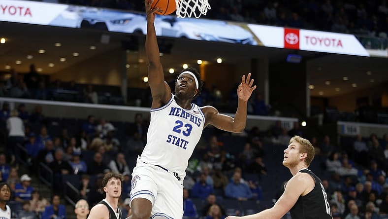 Jan 31, 2024; Memphis, Tennessee, USA; Memphis Tigers forward Malcolm Dandridge (23) drives to the basket as Rice Owls forward Max Fiedler (15) defends during the first half at FedExForum. Mandatory Credit: Petre Thomas-USA TODAY Sports