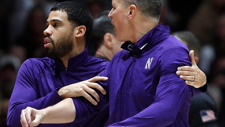 Northwestern Wildcats assistant coach Talor Battle holds back Northwestern Wildcats head coach Chris Collins during the NCAA men   s basketball game against the Purdue Boilermakers, Wednesday, Jan. 31, 2024, at Mackey Arena in West Lafayette, Ind. Purdue Boilermakers 105-96.