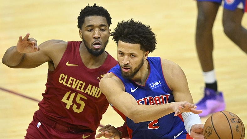 Jan 31, 2024; Cleveland, Ohio, USA; Detroit Pistons guard Cade Cunningham (2) throws a pass beside Cleveland Cavaliers guard Donovan Mitchell (45) in the fourth quarter at Rocket Mortgage FieldHouse. Mandatory Credit: David Richard-USA TODAY Sports