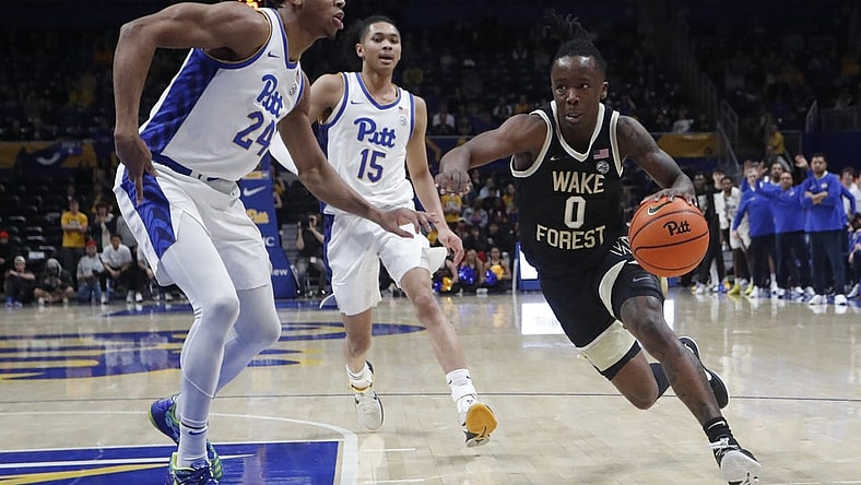 Jan 31, 2024; Pittsburgh, Pennsylvania, USA; Wake Forest Demon Deacons guard Kevin Miller (0) drives to the basket past Pittsburgh Panthers forward William Jeffress (24) and guard Jaland Lowe (15) during the second half at the Petersen Events Center. Pittsburgh won 77-72. Mandatory Credit: Charles LeClaire-USA TODAY Sports