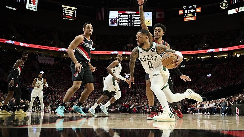 Jan 31, 2024; Portland, Oregon, USA; Milwaukee Bucks guard Damian Lillard (0) drives to the basket during the first half against Portland Trail Blazers guard Anfernee Simons (1) at Moda Center. Mandatory Credit: Troy Wayrynen-USA TODAY Sports