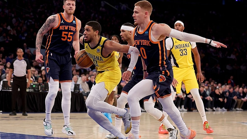 Feb 1, 2024; New York, New York, USA; Indiana Pacers guard Tyrese Haliburton (0) drives to the basket against New York Knicks center Isaiah Hartenstein (55) and guards Josh Hart (3) and Donte DiVincenzo (0) during the first quarter at Madison Square Garden. Mandatory Credit: Brad Penner-USA TODAY Sports