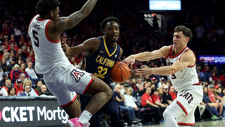 Feb 1, 2024; Tucson, Arizona, USA; California Golden Bears guard Jalen Celestine (32) drives to the net against Arizona Wildcats guard KJ Lewis (5) and guard Pelle Larsson (3) during the first half at McKale Center. Mandatory Credit: Zachary BonDurant-USA TODAY Sports