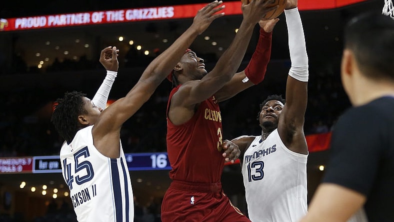 Feb 1, 2024; Memphis, Tennessee, USA; Cleveland Cavaliers guard Caris LeVert (3) drives to the basket between Memphis Grizzlies forward GG Jackson (45) and forward-center Jaren Jackson Jr. (13) during the first half at FedExForum. Mandatory Credit: Petre Thomas-USA TODAY Sports