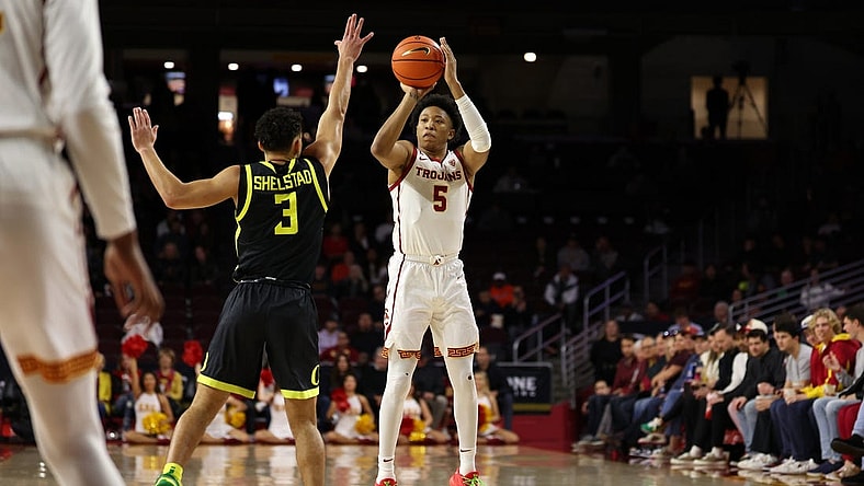 Feb 1, 2024; Los Angeles, California, USA; USC Trojans guard Boogie Ellis (5) shoots the ball over Oregon Ducks guard Jackson Shelstad (3) during the first half at Galen Center. Mandatory Credit: Kiyoshi Mio-USA TODAY Sports