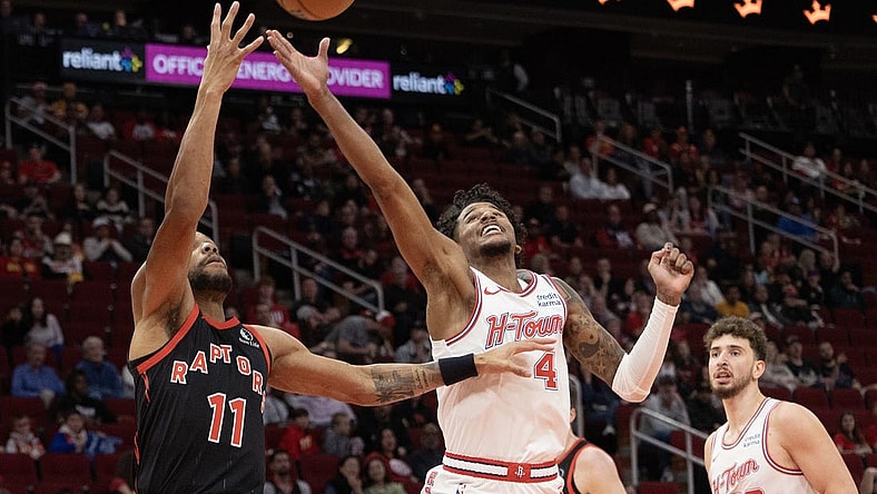 Feb 2, 2024; Houston, Texas, USA; Toronto Raptors forward Bruce Brown (11) and Houston Rockets guard Jalen Green (4) reach for a rebound in the first quarter at Toyota Center. Mandatory Credit: Thomas Shea-USA TODAY Sports
