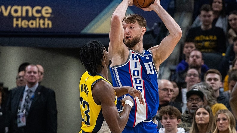 Feb 2, 2024; Indianapolis, Indiana, USA; Sacramento Kings forward Domantas Sabonis (10) holds the ball while  Indiana Pacers forward Aaron Nesmith (23) defends in the first half at Gainbridge Fieldhouse. Mandatory Credit: Trevor Ruszkowski-USA TODAY Sports