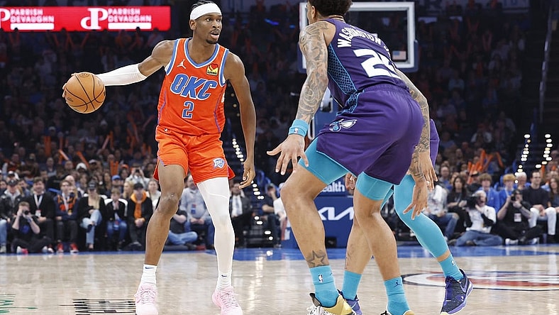 Feb 2, 2024; Oklahoma City, Oklahoma, USA; Oklahoma City Thunder guard Shai Gilgeous-Alexander (2) moves down the court against Charlotte Hornets forward P.J. Washington (25) during the second quarter at Paycom Center. Mandatory Credit: Alonzo Adams-USA TODAY Sports