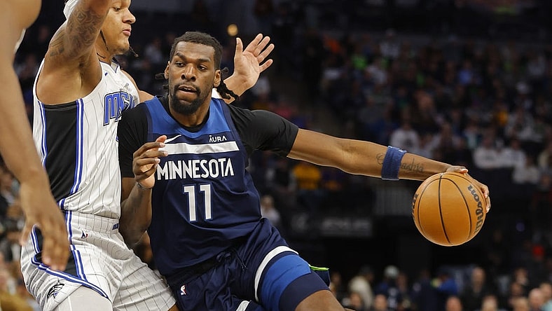 Feb 2, 2024; Minneapolis, Minnesota, USA; Minnesota Timberwolves center Naz Reid (11) works around Orlando Magic forward Paolo Banchero (5) in the first quarter at Target Center. Mandatory Credit: Bruce Kluckhohn-USA TODAY Sports