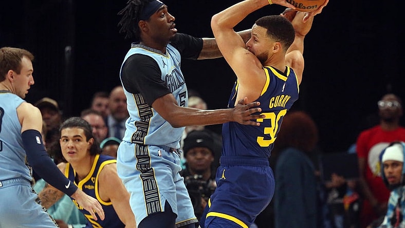 Feb 2, 2024; Memphis, Tennessee, USA; Golden State Warriors guard Stephen Curry (30) handles the ball as Memphis Grizzlies guard Vince Williams Jr. (5) defends during the first half at FedExForum. Mandatory Credit: Petre Thomas-USA TODAY Sports