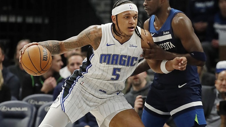 Feb 2, 2024; Minneapolis, Minnesota, USA; Orlando Magic forward Paolo Banchero (5) works around Minnesota Timberwolves guard Anthony Edwards (5) in the first quarter at Target Center. Mandatory Credit: Bruce Kluckhohn-USA TODAY Sports