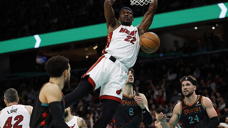 Feb 2, 2024; Washington, District of Columbia, USA; Miami Heat forward Jimmy Butler (22) dunks the ball as Washington Wizards forward Deni Avdija (8) looks on in the first half at Capital One Arena. Mandatory Credit: Geoff Burke-USA TODAY Sports