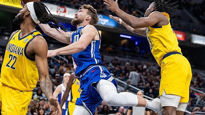 Feb 2, 2024; Indianapolis, Indiana, USA; Sacramento Kings forward Domantas Sabonis (10) shoots the ball while Indiana Pacers forward Isaiah Jackson (22) and forward Aaron Nesmith (23) defend in the second half at Gainbridge Fieldhouse. Mandatory Credit: Trevor Ruszkowski-USA TODAY Sports