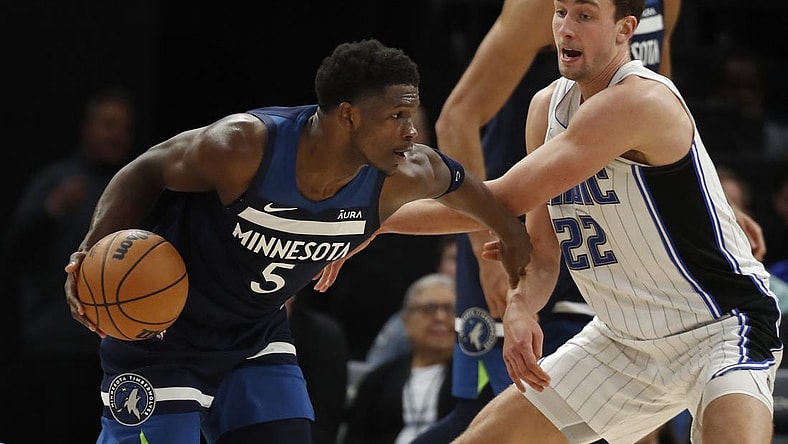 Feb 2, 2024; Minneapolis, Minnesota, USA; Minnesota Timberwolves guard Anthony Edwards (5) works around Orlando Magic forward Franz Wagner (22) in the fourth quarter at Target Center. Mandatory Credit: Bruce Kluckhohn-USA TODAY Sports