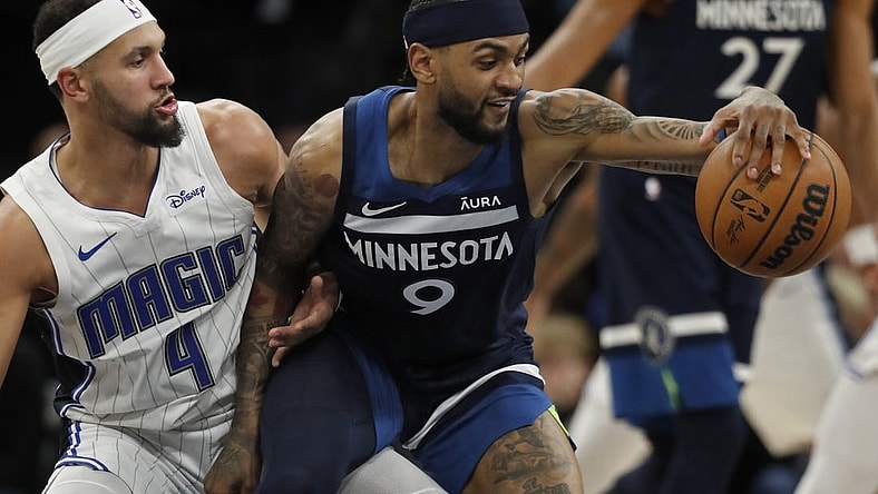 Feb 2, 2024; Minneapolis, Minnesota, USA; Minnesota Timberwolves guard Nickeil Alexander-Walker (9) works around Orlando Magic guard Jalen Suggs (4) in the fourth quarter at Target Center. Mandatory Credit: Bruce Kluckhohn-USA TODAY Sports