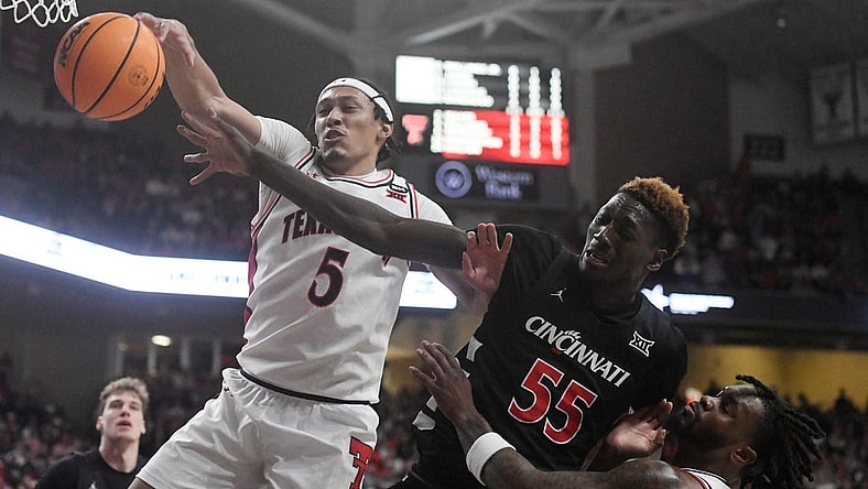 Texas Tech's guard Darrion Williams (5) and Cincinnati's forward Aziz Bandaogo (55) reach for the ball during the Big 12 basketball game, Saturday, Feb. 3, 2024, at United Supermarkets Arena.