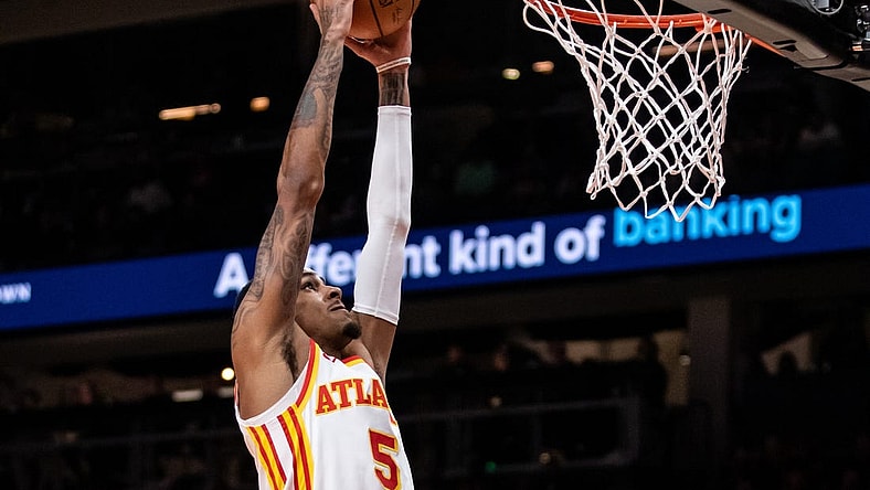 Feb 3, 2024; Atlanta, Georgia, USA; Atlanta Hawks guard Dejounte Murray (5) dunks against Golden State Warriors during the first quarter at State Farm Arena. Mandatory Credit: Jordan Godfree-USA TODAY Sports