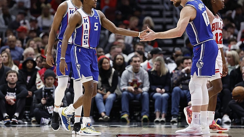 Feb 3, 2024; Chicago, Illinois, USA; Sacramento Kings guard De'Aaron Fox (5) celebrates with forward Domantas Sabonis (10) after scoring against the Chicago Bulls during the first half at United Center. Mandatory Credit: Kamil Krzaczynski-USA TODAY Sports