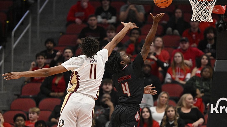 Feb 3, 2024; Louisville, Kentucky, USA; Louisville Cardinals guard Ty-Laur Johnson (4) shoots against Florida State Seminoles forward Baba Miller (11) during the first half at KFC Yum! Center. Mandatory Credit: Jamie Rhodes-USA TODAY Sports