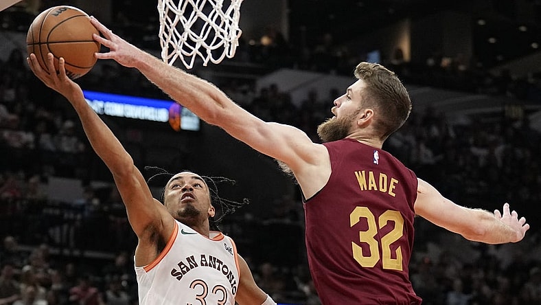 Feb 3, 2024; San Antonio, Texas, USA; Cleveland Cavaliers forward Dean Wade (32) blocks the shot attempted by San Antonio Spurs 33 guard Tre Jones (33) during the first half at Frost Bank Center. Mandatory Credit: Scott Wachter-USA TODAY Sports
