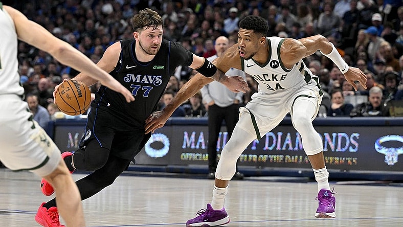 Feb 3, 2024; Dallas, Texas, USA; Dallas Mavericks guard Luka Doncic (77) drives to the basket past Milwaukee Bucks forward Giannis Antetokounmpo (34) during the second quarter at the American Airlines Center. Mandatory Credit: Jerome Miron-USA TODAY Sports