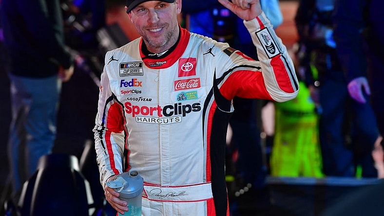 Feb 3, 2024; Los Angeles, California, USA; NASCAR Cup Series driver Denny Hamlin (11) celebrates his victory of the Busch Light Clash at Los Angeles Memorial Coliseum. Mandatory Credit: Gary A. Vasquez-USA TODAY Sports
