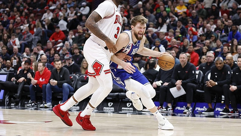 Feb 3, 2024; Chicago, Illinois, USA; Sacramento Kings forward Domantas Sabonis (10) drives to the basket against Chicago Bulls center Andre Drummond (3) during the second half at United Center. Mandatory Credit: Kamil Krzaczynski-USA TODAY Sports