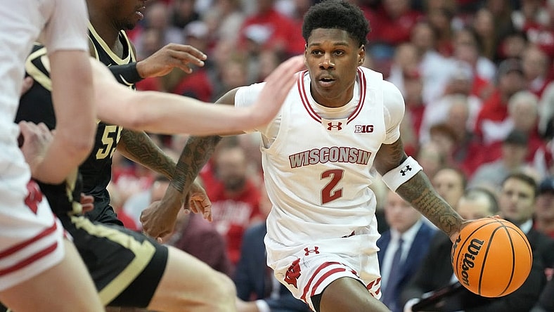 Feb 4, 2024; Madison, Wisconsin, USA; Wisconsin Badgers guard AJ Storr (2) dribbles the ball against Purdue Boilermakers guard Lance Jones (55) during the second half at the Kohl Center. Mandatory Credit: Kayla Wolf-USA TODAY Sports