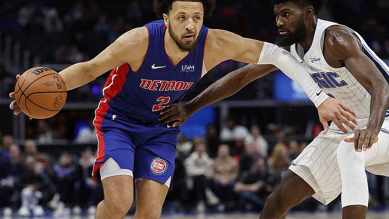 Feb 4, 2024; Detroit, Michigan, USA; Detroit Pistons guard Cade Cunningham (2) dribbles defended by Orlando Magic forward Jonathan Isaac (1) in the second half at Little Caesars Arena. Mandatory Credit: Rick Osentoski-USA TODAY Sports