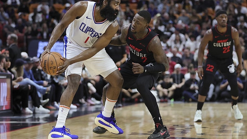 Feb 4, 2024; Miami, Florida, USA; LA Clippers guard James Harden (1) protects the basketball from Miami Heat guard Terry Rozier (2) during the first quarter at Kaseya Center. Mandatory Credit: Sam Navarro-USA TODAY Sports
