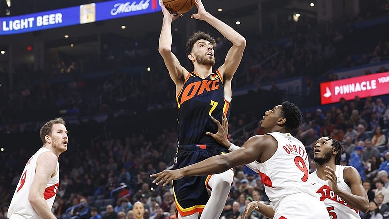 Feb 4, 2024; Oklahoma City, Oklahoma, USA; Oklahoma City Thunder forward Chet Holmgren (7) shoots against Toronto Raptors guard RJ Barrett (9) during the first quarter at Paycom Center. Mandatory Credit: Alonzo Adams-USA TODAY Sports