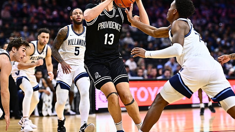 Feb 4, 2024; Philadelphia, Pennsylvania, USA; Providence Friars forward Josh Oduro (13) drives against Villanova Wildcats guard Jordan Longino (15) in the first half at Wells Fargo Center. Mandatory Credit: Kyle Ross-USA TODAY Sports