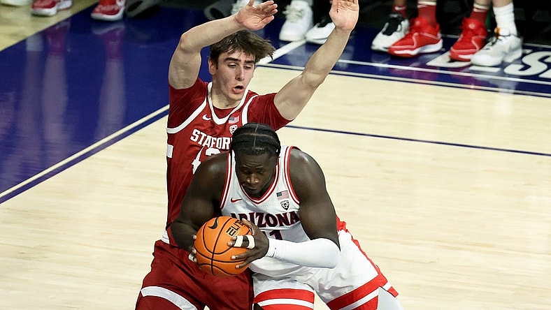 Feb 4, 2024; Tucson, Arizona, USA; Arizona Wildcats center Oumar Ballo (11) drives to the net against Stanford Cardinal forward Maxime Raynaud (42) during the first half at McKale Center. Mandatory Credit: Zachary BonDurant-USA TODAY Sports