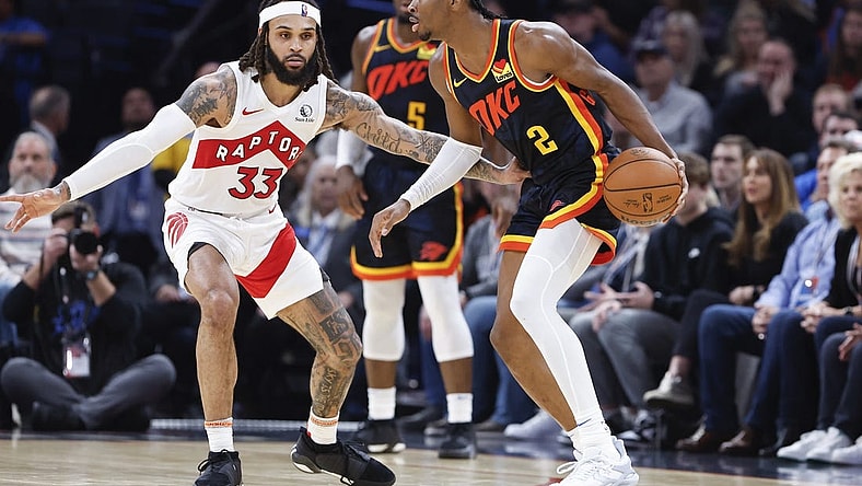Feb 4, 2024; Oklahoma City, Oklahoma, USA; Oklahoma City Thunder guard Shai Gilgeous-Alexander (2) moves the ball against Toronto Raptors guard Gary Trent Jr. (33) during the second half at Paycom Center. Mandatory Credit: Alonzo Adams-USA TODAY Sports