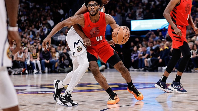 Feb 4, 2024; Denver, Colorado, USA; Portland Trail Blazers guard Scoot Henderson (00) controls the ball as Denver Nuggets forward Peyton Watson (8) guards in the third quarter at Ball Arena. Mandatory Credit: Isaiah J. Downing-USA TODAY Sports