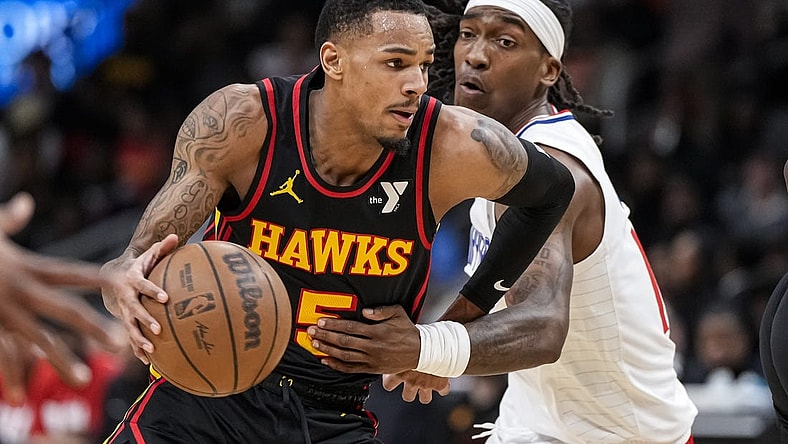 Feb 5, 2024; Atlanta, Georgia, USA; Atlanta Hawks guard Dejounte Murray (5) dribbles past LA Clippers guard Terance Mann (14) during the first half at State Farm Arena. Mandatory Credit: Dale Zanine-USA TODAY Sports